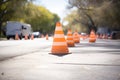 safety cones forming a line on a newly tarred road Royalty Free Stock Photo