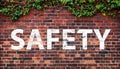 SAFETY on dark texture of old red bricks wall Royalty Free Stock Photo