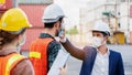 Safety of engineering team or foreman Have a helmet, Body thermometer to healthy while working and mask in factory or container.