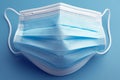 Safety essentials Isolated stack of protective medical masks on blue