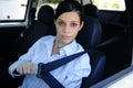 Safety: female driver fastening seat belt