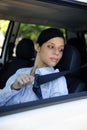 Safety: female driver fastening seat belt