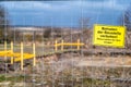 Sign with the German inscription `Do not enter the construction site. Parents are responsible for their children` on a site fence