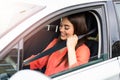 Safety first. Beautiful Caucasian lady fastening car seat belt. Pretty young woman driving her new car. Pretty young woman driving Royalty Free Stock Photo