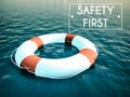 Safety First sign lifebuoy on rough water waves Royalty Free Stock Photo