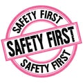 SAFETY FIRST text on pink-black round stamp sign Royalty Free Stock Photo