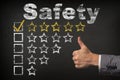 Safety five 5 star rating. thumbs up service golden rating stars on chalkboard Royalty Free Stock Photo