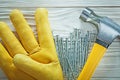 Safety glove claw hammer stainless nails on wooden board Royalty Free Stock Photo