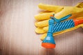 Safety gloves with garden water sprayer on wooden board gardenin Royalty Free Stock Photo