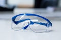 Safety goggles and blue gloves Royalty Free Stock Photo