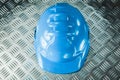 Safety hard hat on grooved metal sheet