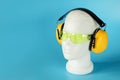 Safety headphones protection of hearing from noise, protective glasses, head of mannequin