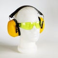 Safety headphones protection of hearing from noise, protective glasses, head of mannequin close-up