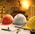 Safety helmet on architect ,engineer working table with modern b