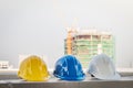 The safety helmet and the blueprint at construction site with crane background Royalty Free Stock Photo