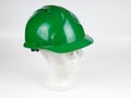 Safety helmet, green hard hat, mannequin head, health protection and safety precautions at work Royalty Free Stock Photo