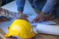 Safety helmet placed on a meeting table engineering team. /Selective focus at safety helmet.