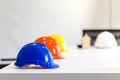 Safety helmet on table in office , engineer concept Teamwork of