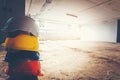 Safety helmet, white, yellow, blue and orange, placed on the cement floor in the construction site Royalty Free Stock Photo