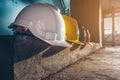 Safety helmet, white, yellow, blue and orange, placed on the cement floor in the construction site Royalty Free Stock Photo