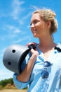 Safety, helmet and woman on blue sky for adventure, outdoor and thinking in countryside with a smile. Happy, person and Royalty Free Stock Photo