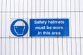 Safety helmets hard hats must be worn sign at construction site Royalty Free Stock Photo