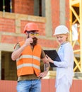 Safety inspector concept. Discuss progress project. Inspector and bearded brutal builder discuss construction progress Royalty Free Stock Photo