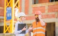 Safety inspector concept. Inspector and bearded brutal builder discuss construction progress. Construction project Royalty Free Stock Photo