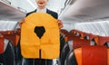 Safety instructions. Young stewardess on the work in the passanger airplane