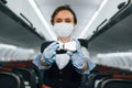 Safety instructions. Young stewardess on the work in the passanger airplane