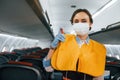 Safety instructions. Young stewardess on the work in the passanger airplane