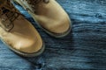 Safety lace boots on wooden board Royalty Free Stock Photo