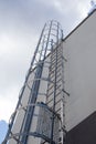 Safety metal ladder to the roof and blue sky, iron staircase Royalty Free Stock Photo