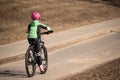 Safety in a modern European city. Young boy rides bike through park Royalty Free Stock Photo