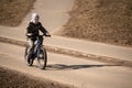 Safety in a modern European city. Young boy rides bike through park Royalty Free Stock Photo