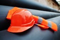 Safety orange worker helmet at steel pipes. Royalty Free Stock Photo