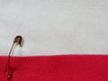 Safety pin on fabric background