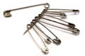 Safety pin in silver over white Royalty Free Stock Photo