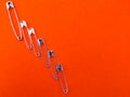 Safety pins are arranged like taller to smaller. Royalty Free Stock Photo