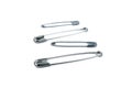 Safety pins standing one after another isolated on white background Royalty Free Stock Photo