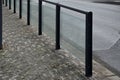 Safety railings on the sidewalk protect people from falling into the traffic road. railings are most often installed at schools an