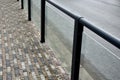 Safety railings on the sidewalk protect people from falling into the traffic road. railings are most often installed at schools an