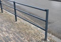 Safety railings on the sidewalk protect people from falling into the traffic road. railings are most often installed at schools an
