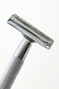 A safety razor with a metallic handle and blade, isolated on a white background Royalty Free Stock Photo