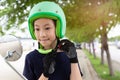 Safety riding concept.Happy asian girl before riding on motorbike with helmet,motorcyclist wearing safe helmet before travel on m Royalty Free Stock Photo