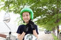 Safety riding concept.Happy asian girl before riding on motorbike with helmet,motorcyclist wearing safe helmet before travel Royalty Free Stock Photo