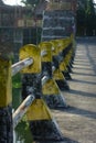 Safety road fence on the street paint in black and yellow Royalty Free Stock Photo