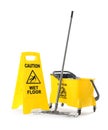 Safety sign with phrase Caution wet floor, mop and bucket on white background. Cleaning service Royalty Free Stock Photo