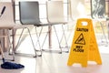 Safety sign with phrase Caution wet floor and mop Royalty Free Stock Photo