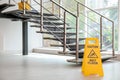 Safety sign with phrase Caution wet floor near stairs Royalty Free Stock Photo